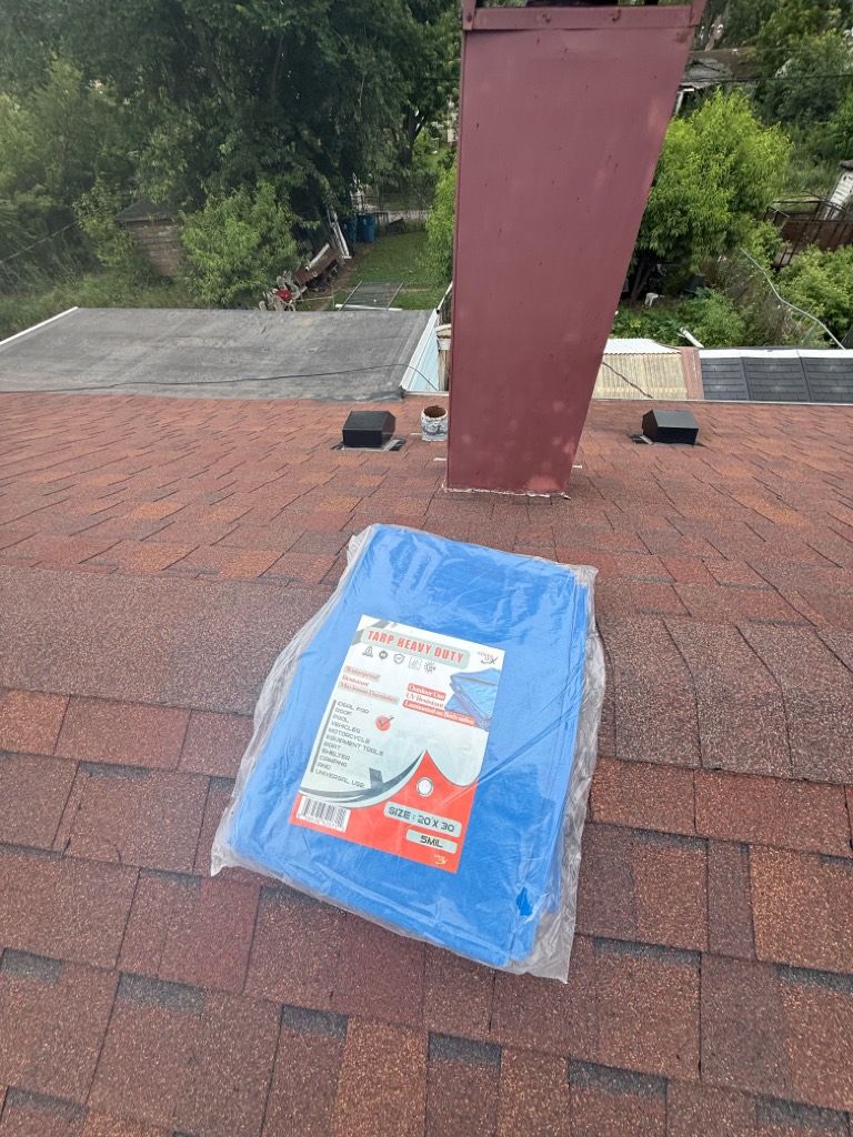Roll of tarp on the roof ready to install